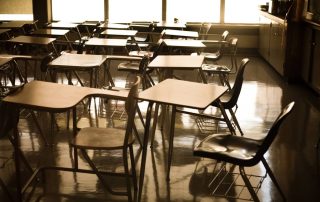 Classroom desks in a classroom with no students at dusk