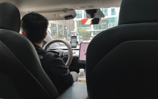 View from the backseat of a rideshare vehicle with a male driver