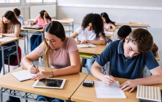 Students in a classroom sitting at desks doing school work